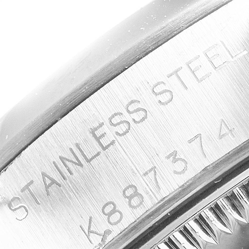 The image shows a close-up of the stainless steel casing and serial number of a Rolex Oyster Perpetual 76080 Women
s Stainless Steel White Dial 76080 Women
s Stainless Steel White Dial watch.