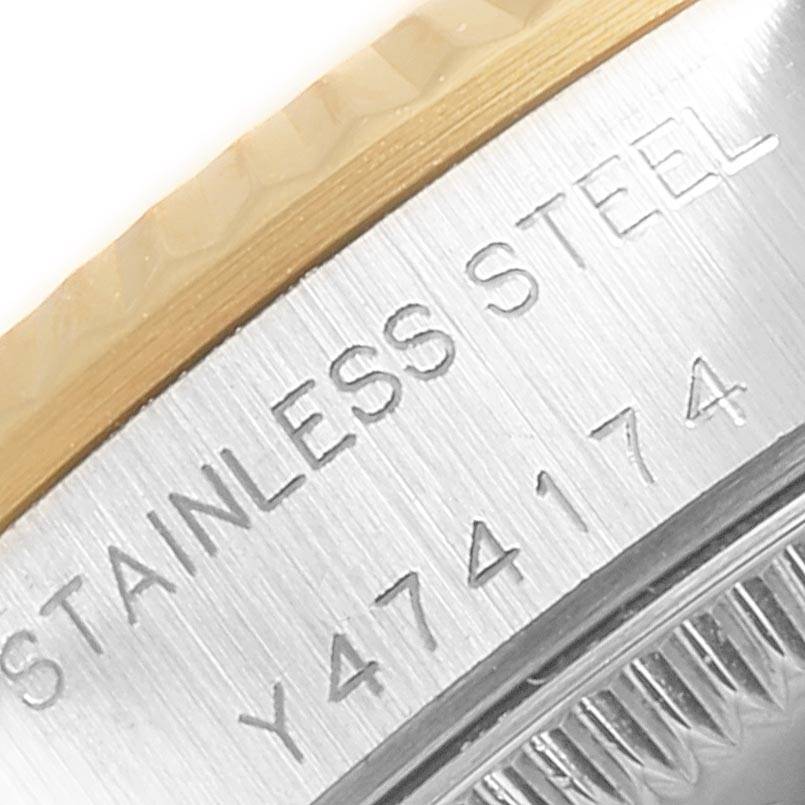 This close-up image shows the stainless steel engravings and bezel of a Rolex Oyster Perpetual 76193 Women
s Steel and Gold (two tone) Champagne Dial 76193 Women
s Steel and Gold (two tone) Champagne Dial watch.