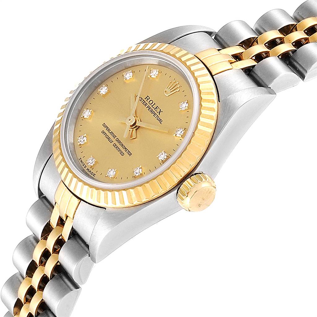This image shows a side angle of a Rolex Oyster Perpetual 76193 Women
s Steel and Gold (two tone) Champagne Dial 76193 Women
s Steel and Gold (two tone) Champagne Dial watch featuring its gold bezel, crown, and two-tone bracelet with diamond hour markers.