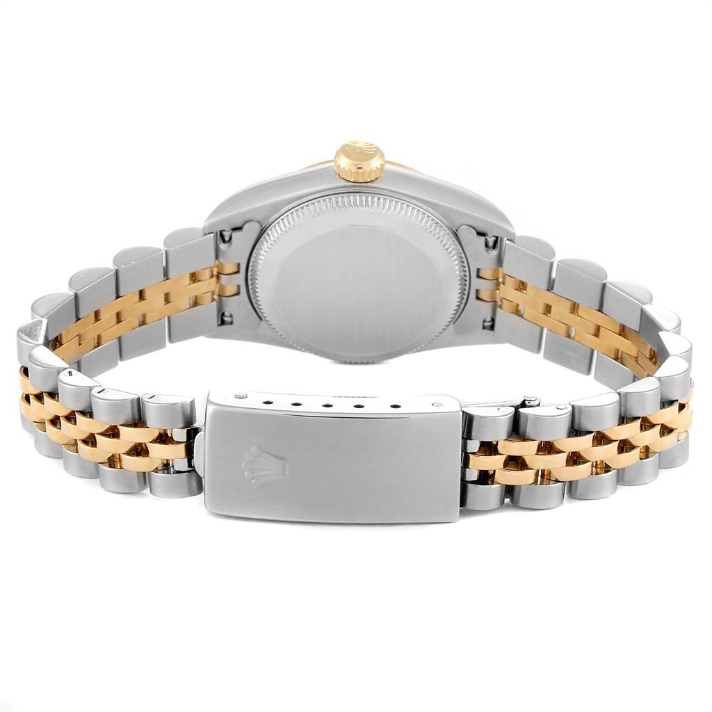 The image shows the back of the Rolex Oyster Perpetual 76193 Women
s Steel and Gold (two tone) Champagne Dial 76193 Women
s Steel and Gold (two tone) Champagne Dial watch, including the case and the two-tone bracelet with the clasp open.