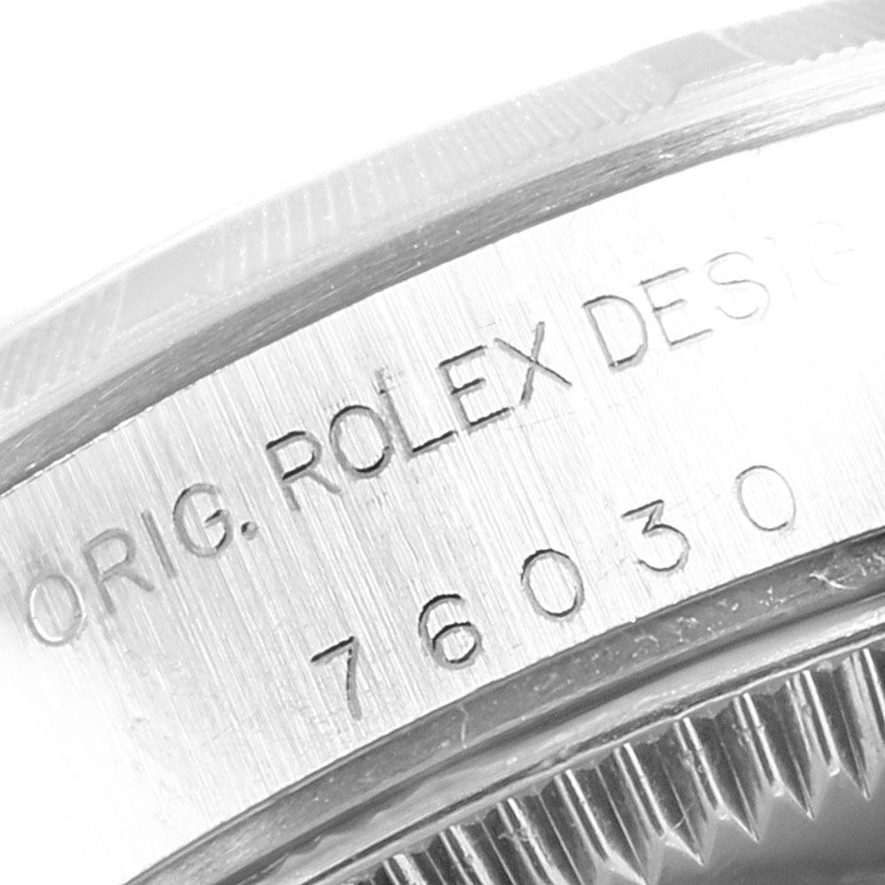 The image shows a close-up of the serial number and "ORIG. ROLEX DESIGN" engraving on the case of a Rolex Oyster Perpetual 76030 Women's Stainless Steel Pink Dial 76030 Women's Stainless Steel Pink Dial.