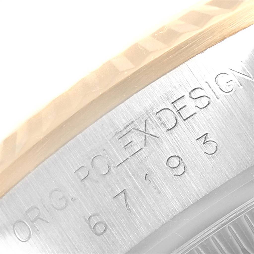 The image displays a close-up of the bezel and the engraved serial number on the side of the Rolex Oyster Perpetual 67193 Women's Steel and Gold (two tone) Grey Dial 67193 Women's Steel and Gold (two tone) Grey Dial watch.