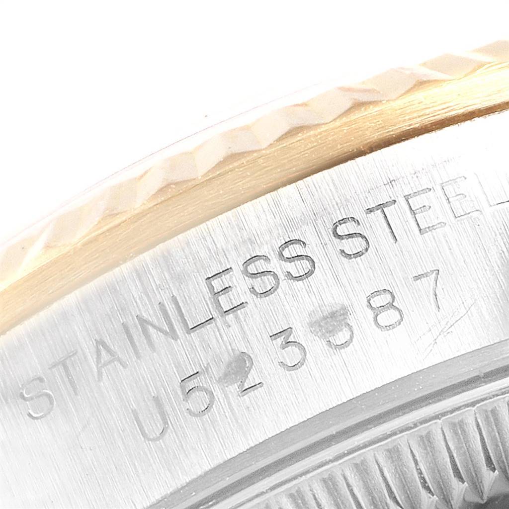This image shows a close-up of the side and part of the bezel of a Rolex Oyster Perpetual 67193 Women's Steel and Gold (two tone) Grey Dial 67193 Women's Steel and Gold (two tone) Grey Dial watch with "stainless steel" engraving.