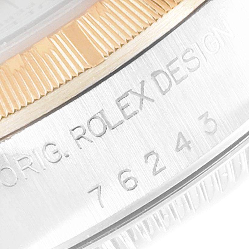 This close-up image shows the side of the Rolex Oyster Perpetual 76243 Women's Steel and Gold (two tone) Silver Dial 76243 Women's Steel and Gold (two tone) Silver Dial watch, including the bezel and engraved model number.