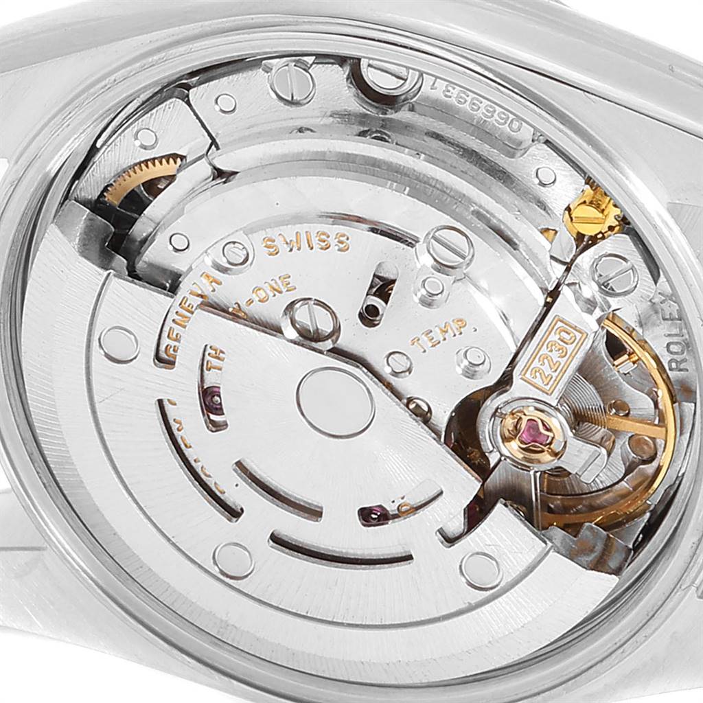 The image shows the movement of a Rolex Oyster Perpetual 76243 Women's Steel and Gold (two tone) Silver Dial 76243 Women's Steel and Gold (two tone) Silver Dial from the rear, highlighting its intricate mechanical components.