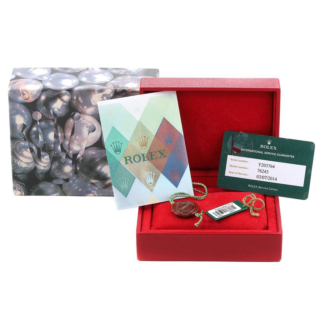 The image shows a Rolex box with an Oyster Perpetual model card, tag, booklet, and guarantee card.