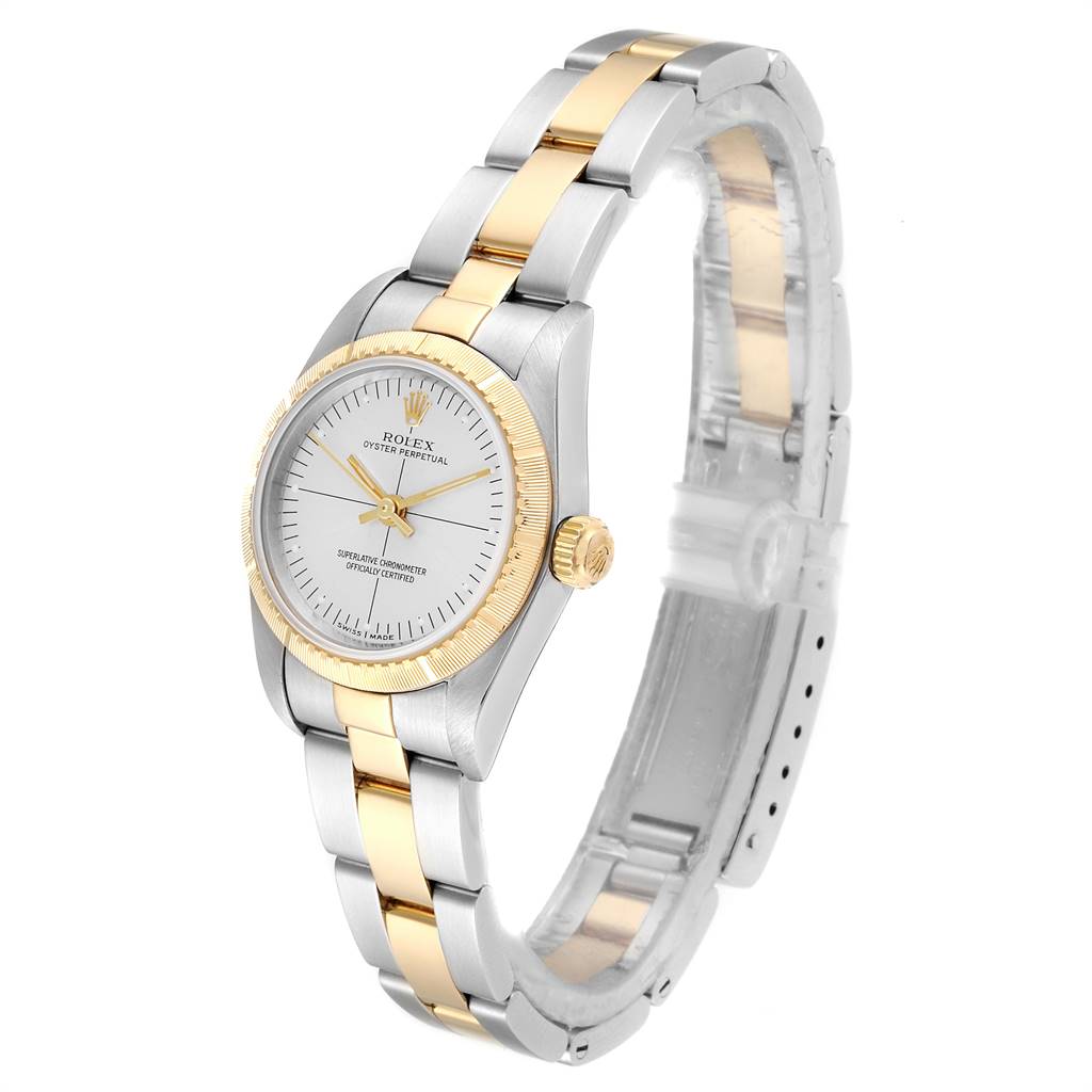 A side angle view of the Rolex Oyster Perpetual 76243 Women's Steel and Gold (two tone) Silver Dial 76243 Women's Steel and Gold (two tone) Silver Dial watch shows the face, bezel, and bracelet in gold and stainless steel.