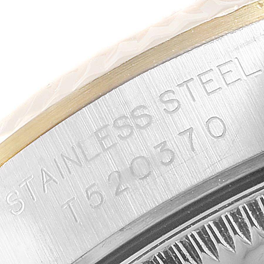 The image shows a close-up angle of the side of the case of a Rolex Oyster Perpetual 67193 Women's Stainless Steel Champagne Dial 67193 Women's Stainless Steel Champagne Dial watch, highlighting the stainless steel engraving.