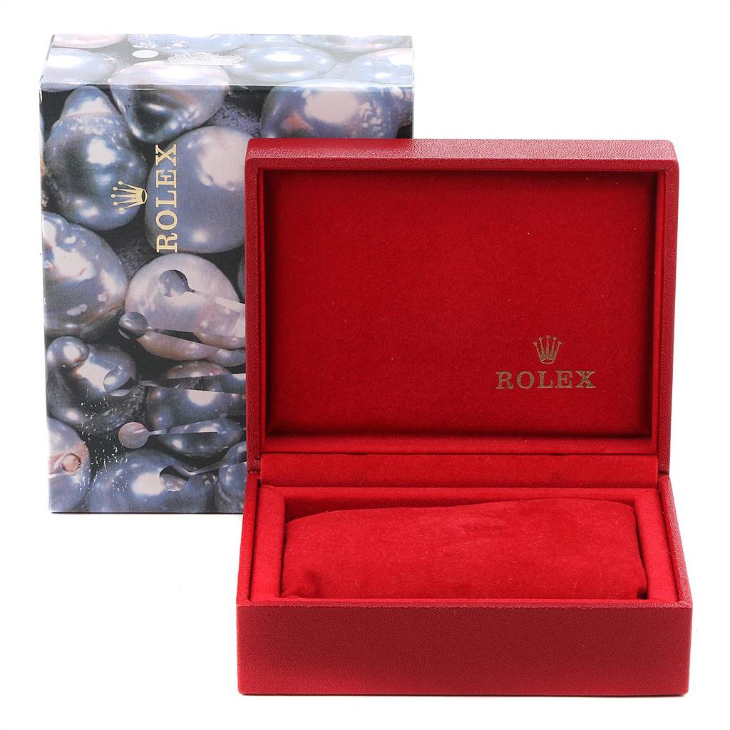 This image shows a Rolex Oyster Perpetual 67193 Women's Stainless Steel Champagne Dial 67193 Women's Stainless Steel Champagne Dial watch box with the cover open, revealing its red velvet interior.