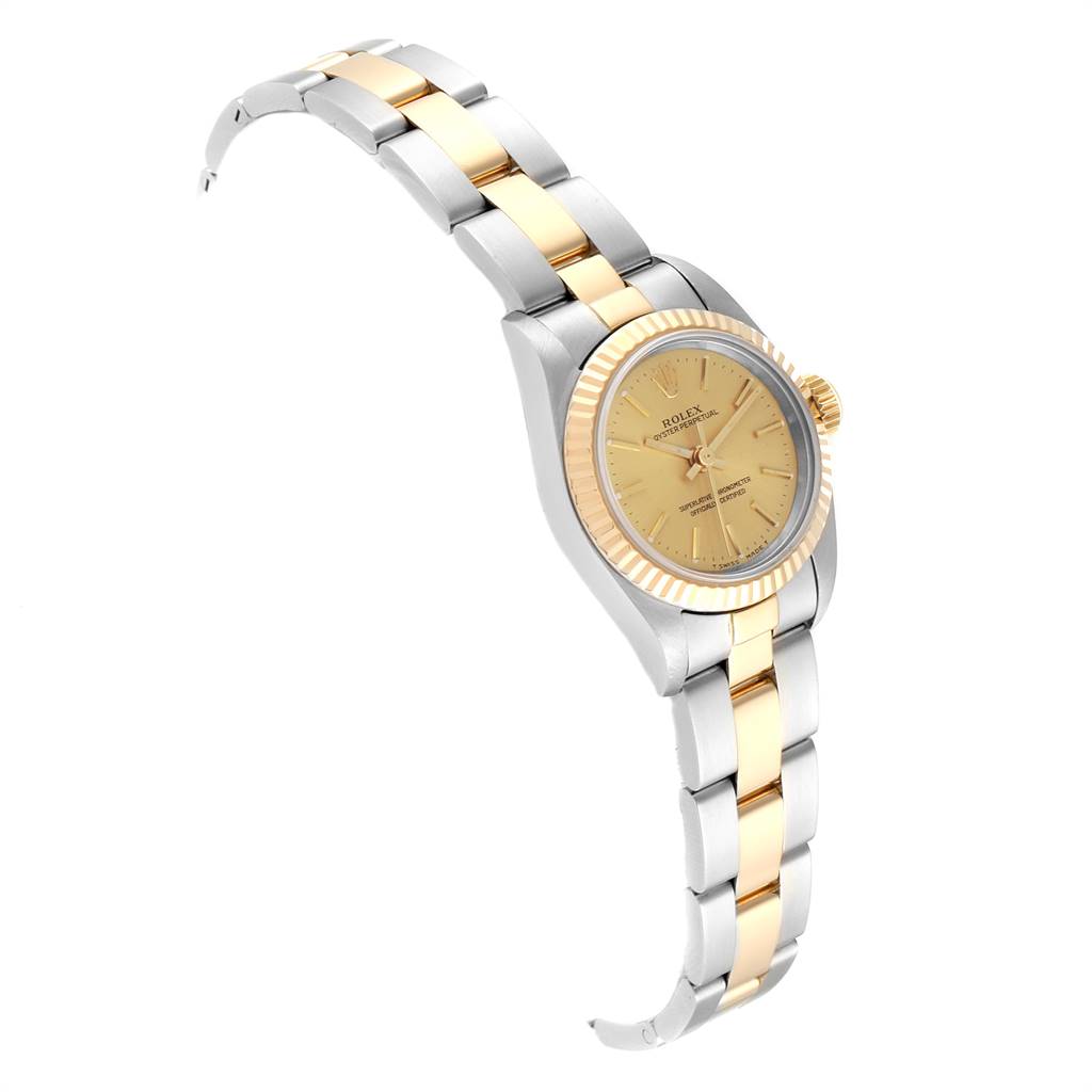 The image shows a side view of the Rolex Oyster Perpetual 67193 Women's Stainless Steel Champagne Dial 67193 Women's Stainless Steel Champagne Dial watch, highlighting its gold and silver bracelet and gold bezel.