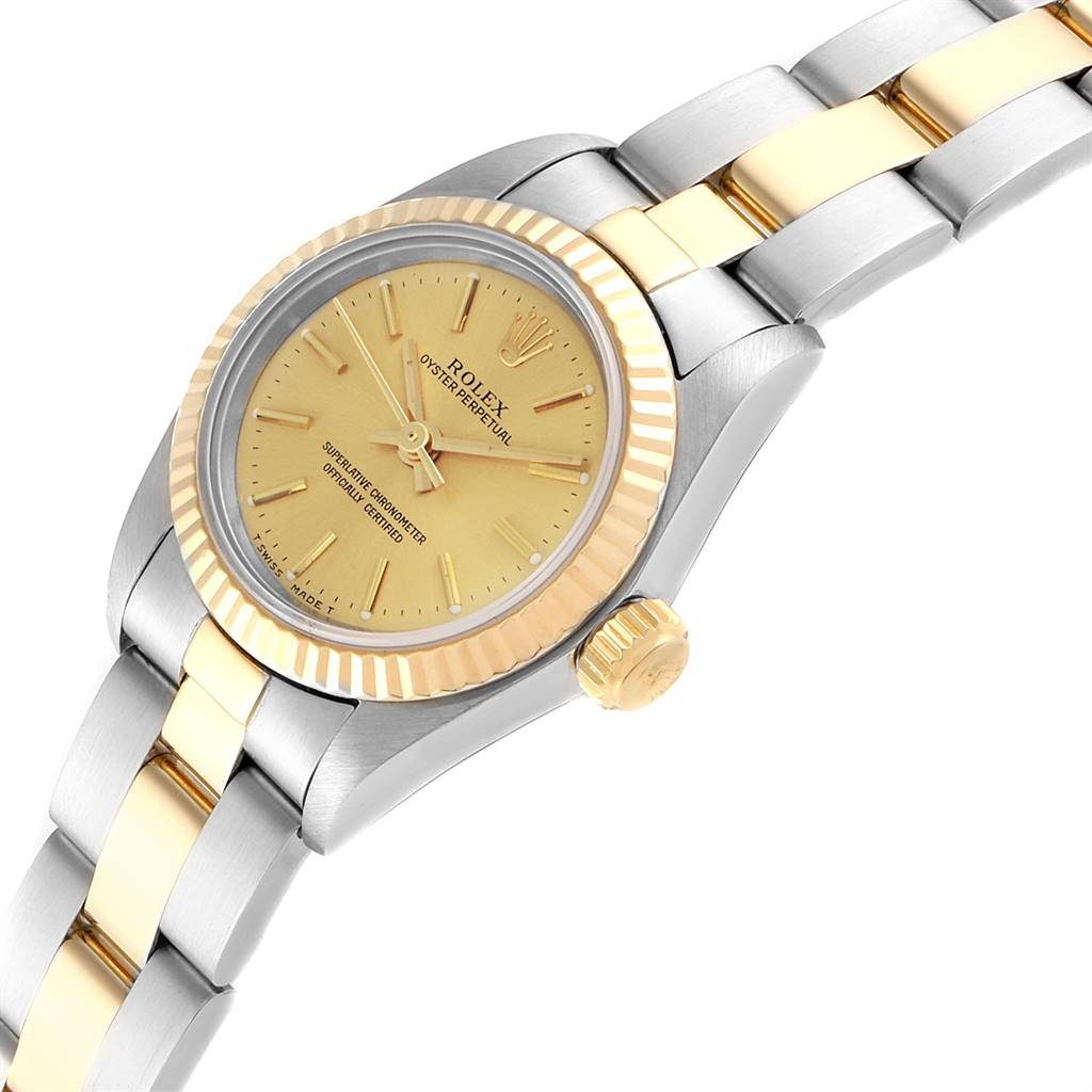 This image shows an angled view of the Rolex Oyster Perpetual 67193 Women's Stainless Steel Champagne Dial 67193 Women's Stainless Steel Champagne Dial watch, highlighting its gold dial, bezel, crown, and bracelet links.