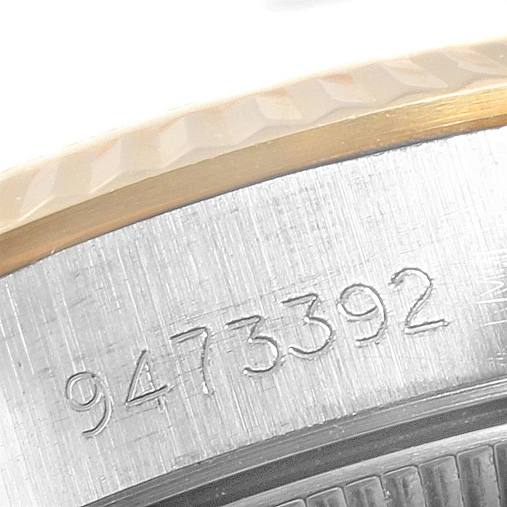 The image shows a close-up view of the bezel and case side of a Rolex Oyster Perpetual 67193 Women
s Steel and Gold (two tone) Champagne Dial 67193 Women
s Steel and Gold (two tone) Champagne Dial watch, featuring an engraved serial number.