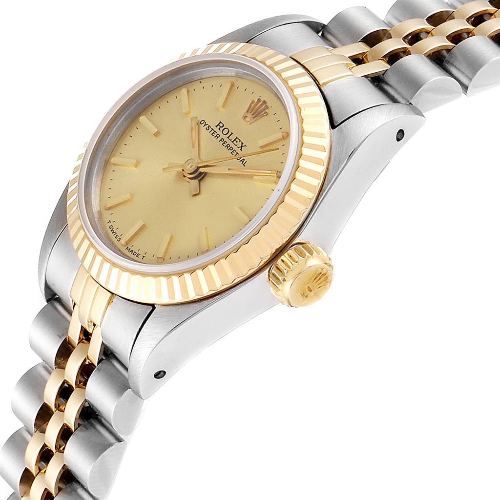 The image shows a side-angle view of a Rolex Oyster Perpetual 67193 Women
s Steel and Gold (two tone) Champagne Dial 67193 Women
s Steel and Gold (two tone) Champagne Dial watch, highlighting the dial, bezel, crown, and part of the bracelet.
