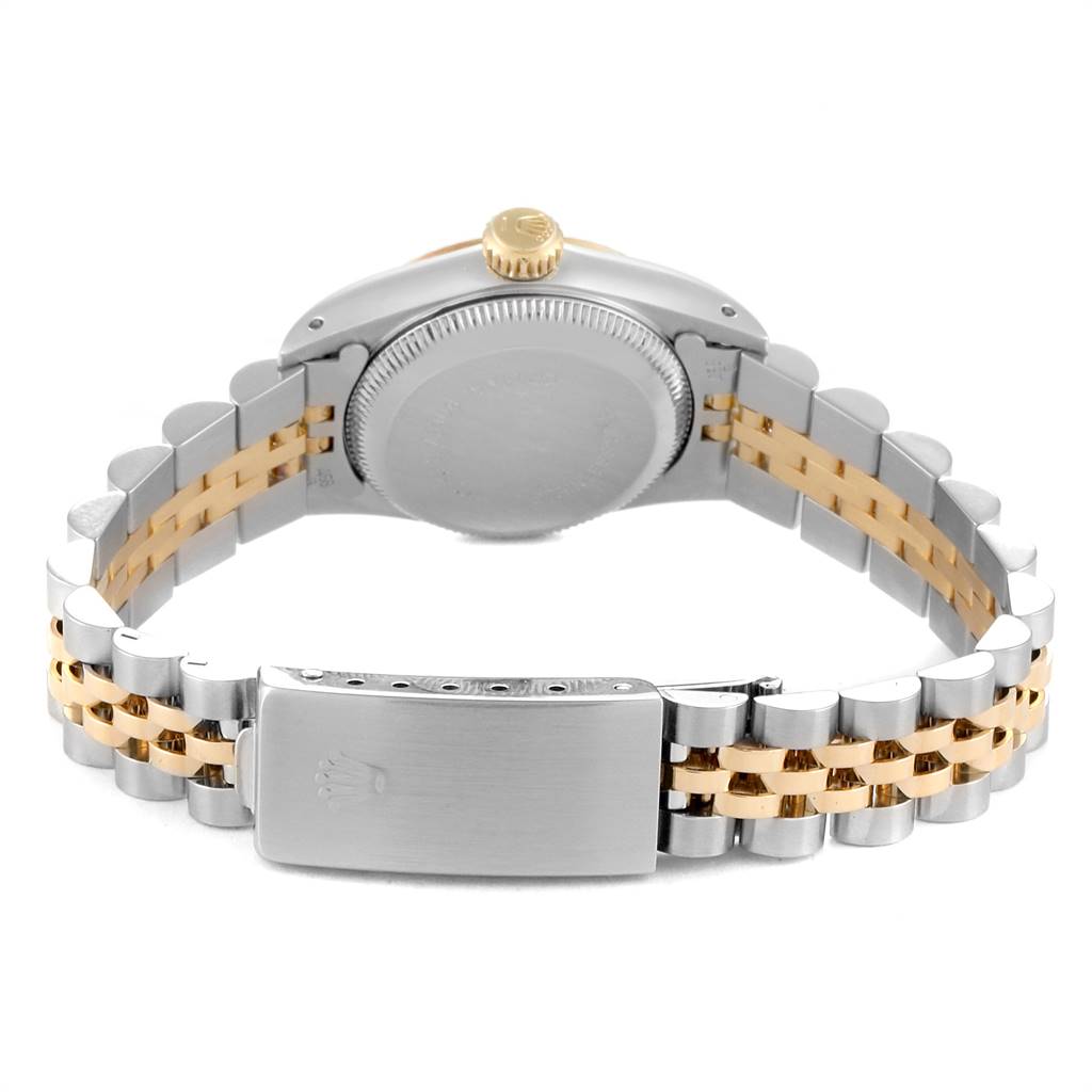 The image shows the back of a Rolex Oyster Perpetual 67193 Women
s Steel and Gold (two tone) Champagne Dial 67193 Women
s Steel and Gold (two tone) Champagne Dial watch, focusing on the case back and the two-tone metal bracelet with the clasp.