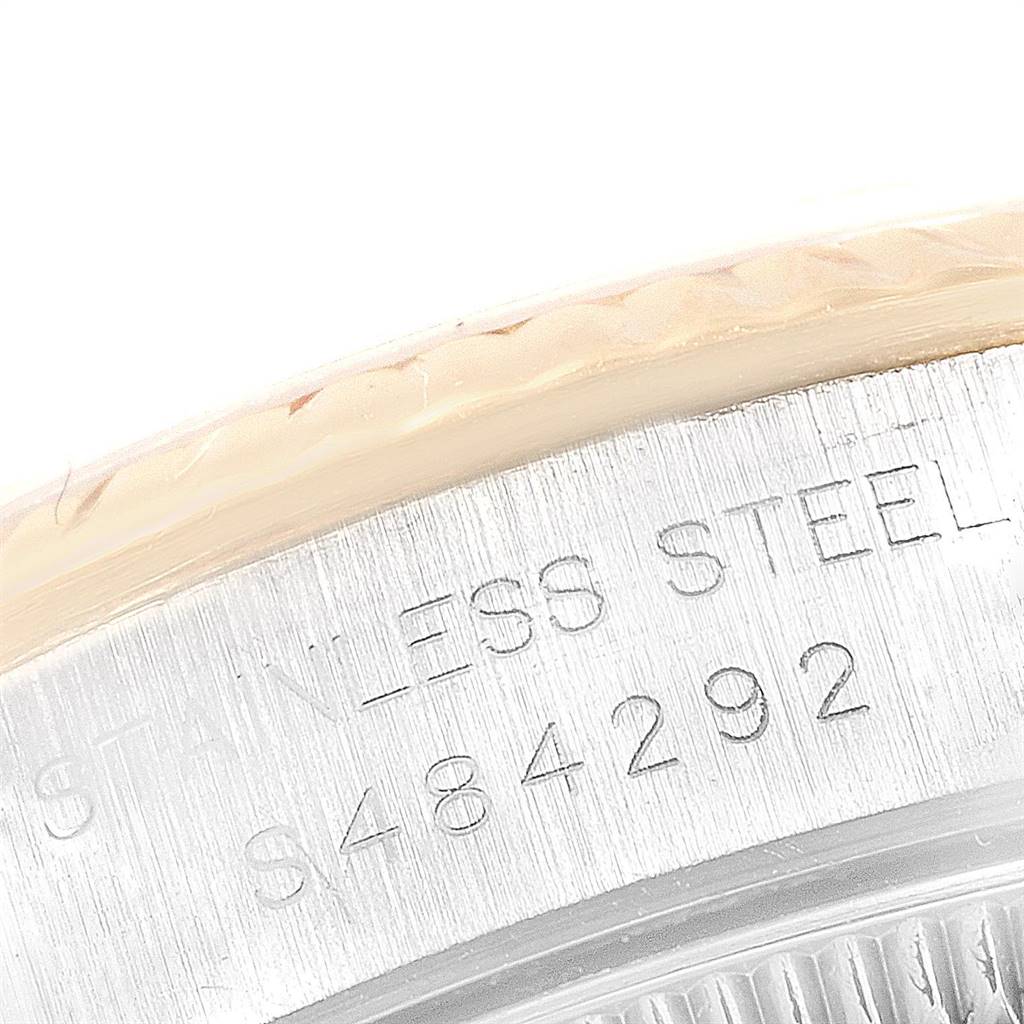 This close-up image shows the engraved serial number and "STAINLESS STEEL" text on the case back of a Rolex Oyster Perpetual 67193 Women
s Steel and Gold (two tone) Champagne Dial 67193 Women
s Steel and Gold (two tone) Champagne Dial watch.