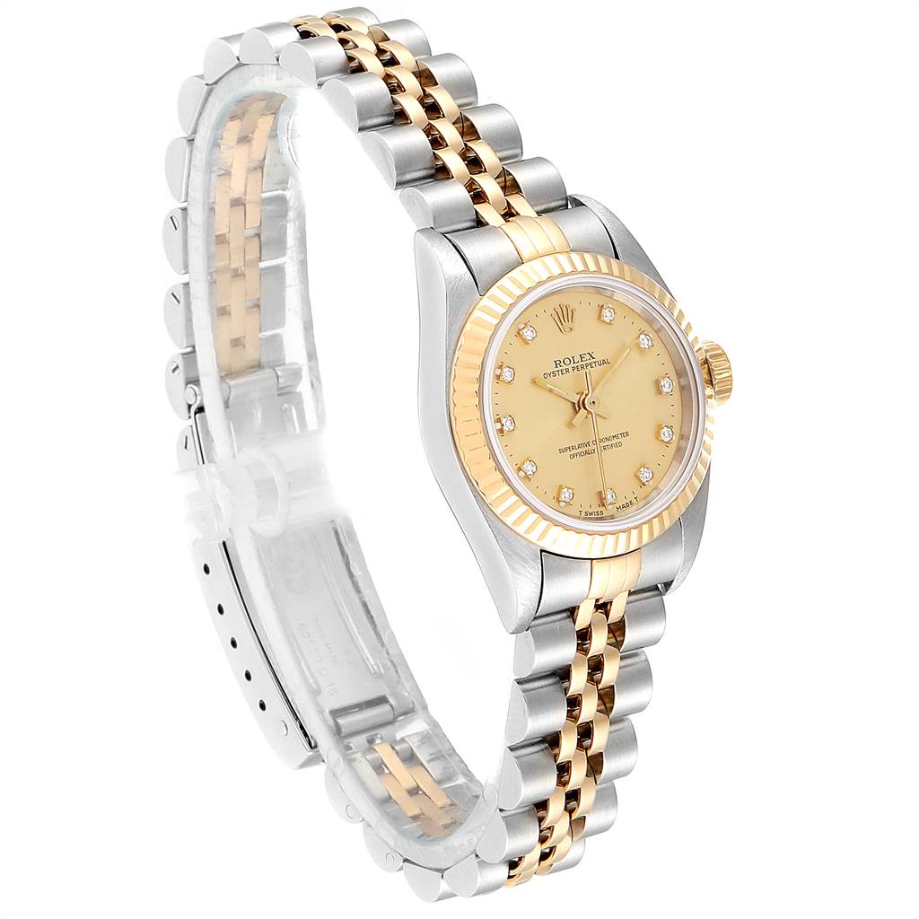 The image shows a side angle of a Rolex Oyster Perpetual 67193 Women
s Steel and Gold (two tone) Champagne Dial 67193 Women
s Steel and Gold (two tone) Champagne Dial watch, highlighting its gold and silver bracelet and the watch face.