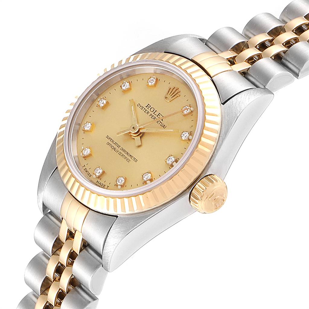 The Rolex Oyster Perpetual 67193 Women
s Steel and Gold (two tone) Champagne Dial 67193 Women
s Steel and Gold (two tone) Champagne Dial watch is shown at a slight angle, highlighting its gold bezel, crown, and part of the bracelet.