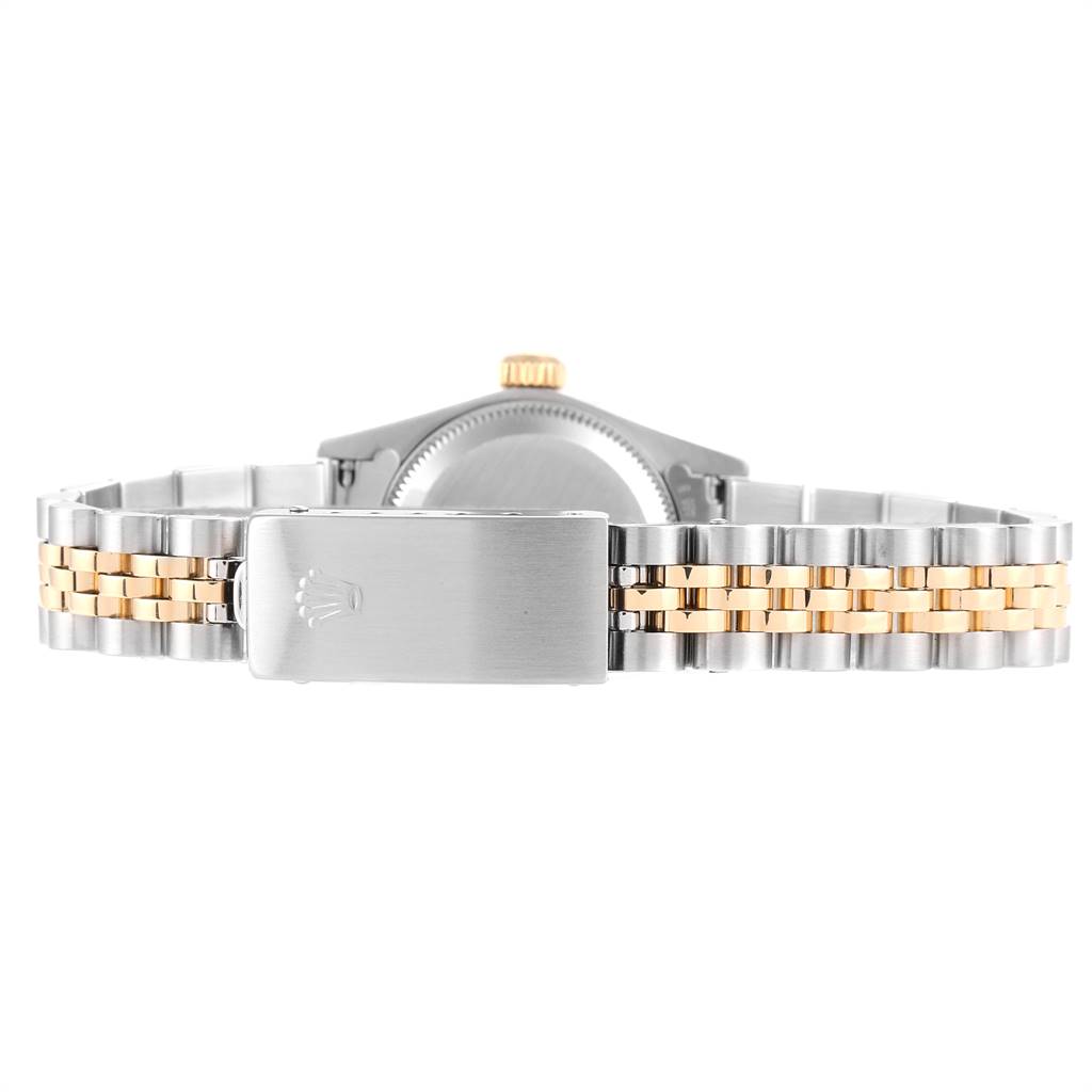 The image shows the back view of a Rolex Oyster Perpetual 67193 Women
s Steel and Gold (two tone) Champagne Dial 67193 Women
s Steel and Gold (two tone) Champagne Dial watch, highlighting its two-tone bracelet and clasp.