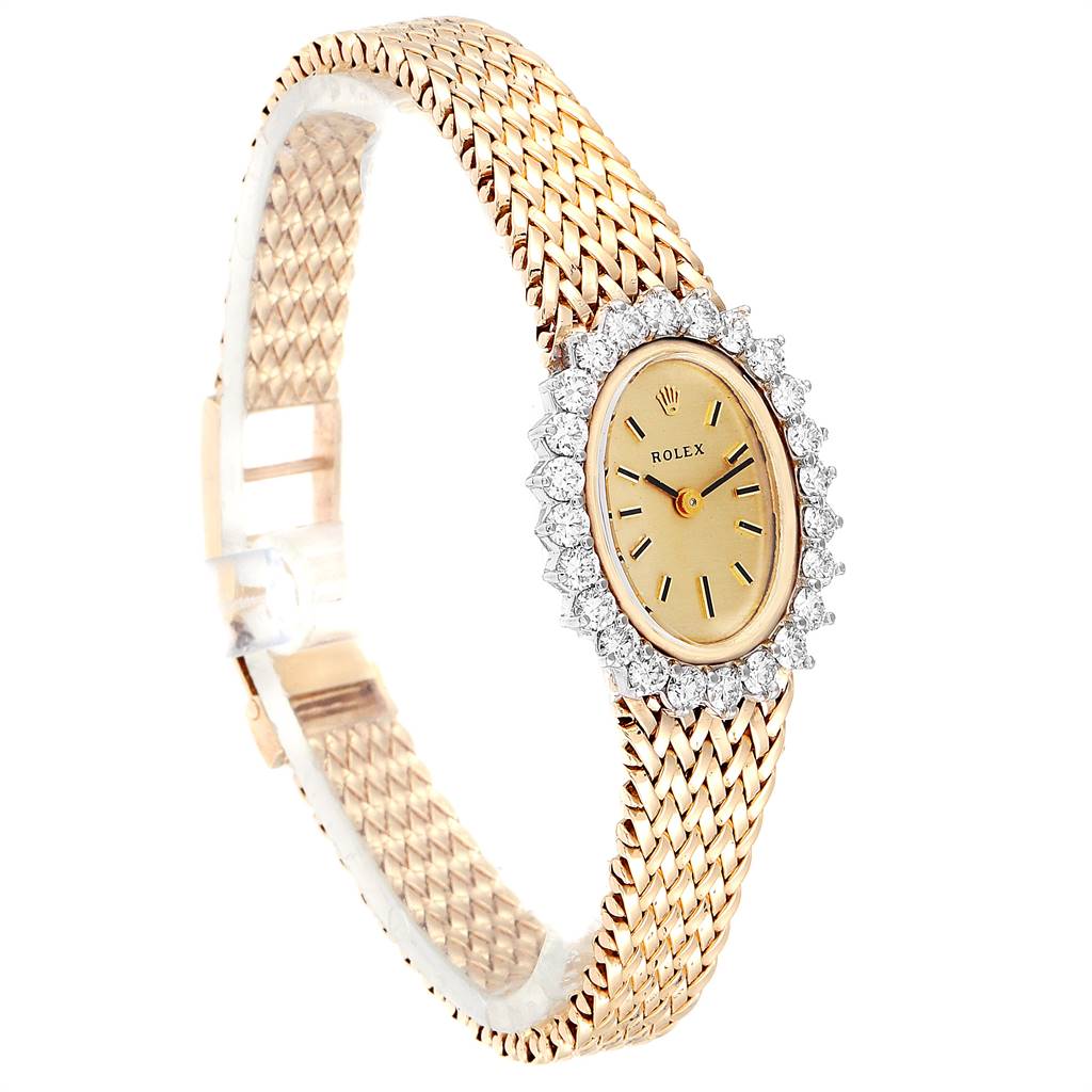 The Rolex Oyster Perpetual Women
s Yellow Gold Champagne Dial Women
s Yellow Gold Champagne Dial watch is shown at a slight angle, featuring its gold bracelet, oval dial, and diamond-accented bezel.