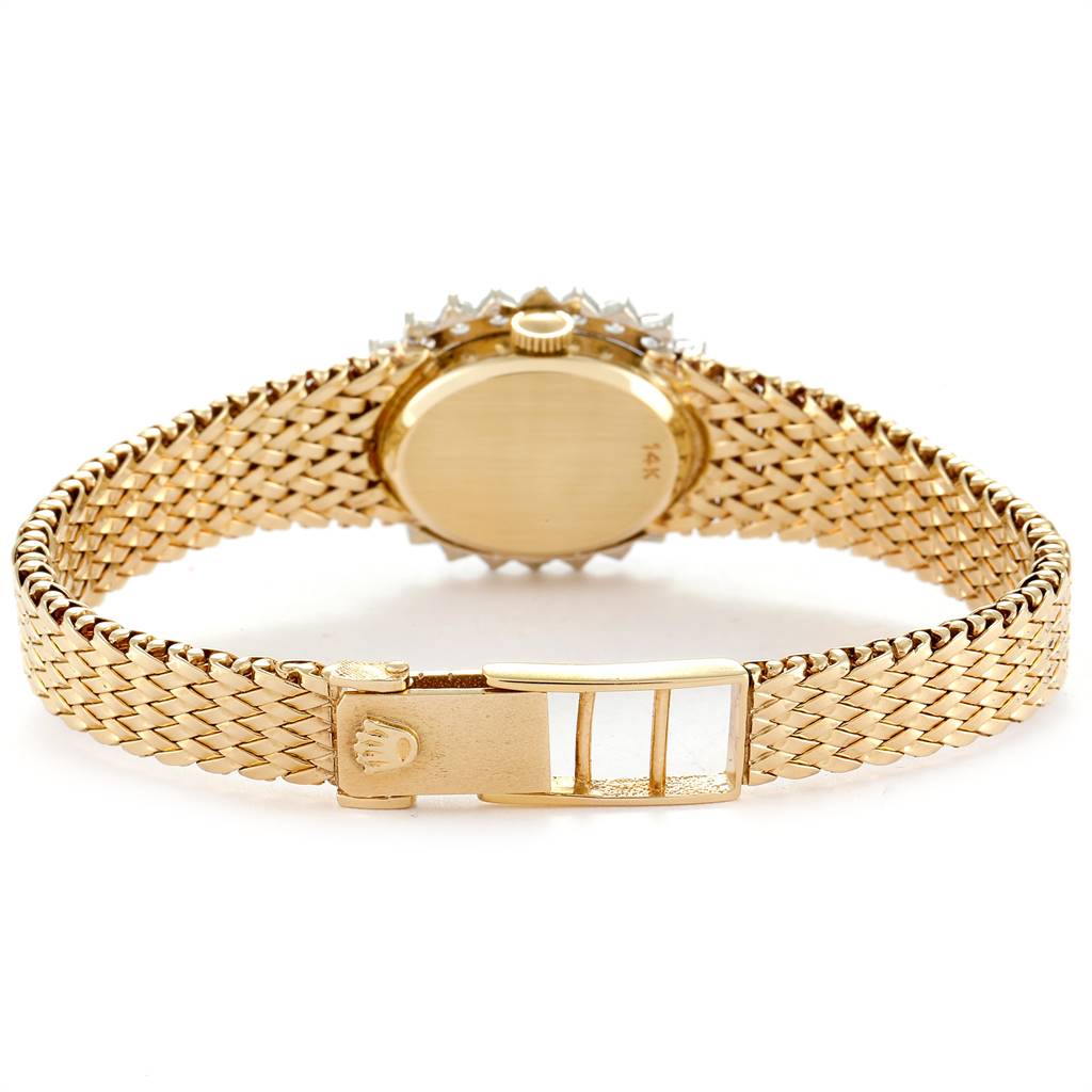 This image shows the back view of the Rolex Oyster Perpetual Women
s Yellow Gold Champagne Dial Women
s Yellow Gold Champagne Dial watch featuring its gold case, crown, and bracelet with the clasp open.