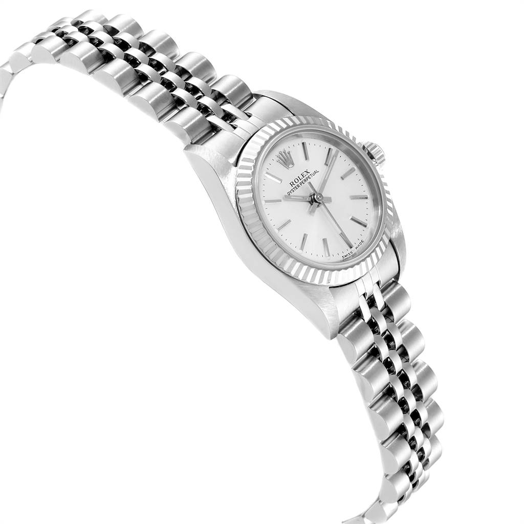The image shows a side view of the Rolex Oyster Perpetual 76094 Women's Stainless Steel Silver Dial 76094 Women's Stainless Steel Silver Dial watch, highlighting its face, bezel, and bracelet.