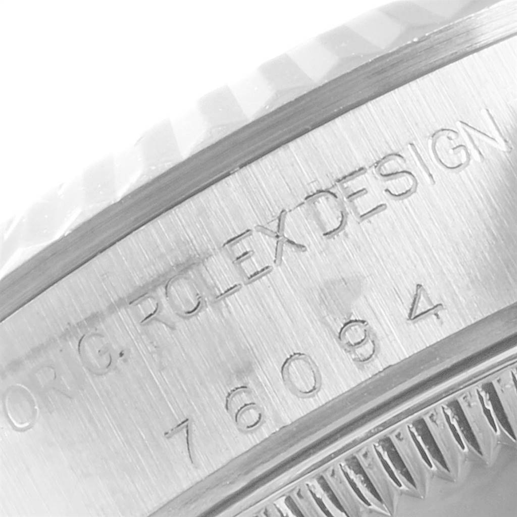 The image shows a close-up of the case side and edge of a Rolex Oyster Perpetual 76094 Women's Stainless Steel Silver Dial 76094 Women's Stainless Steel Silver Dial watch, highlighting the engraved details.