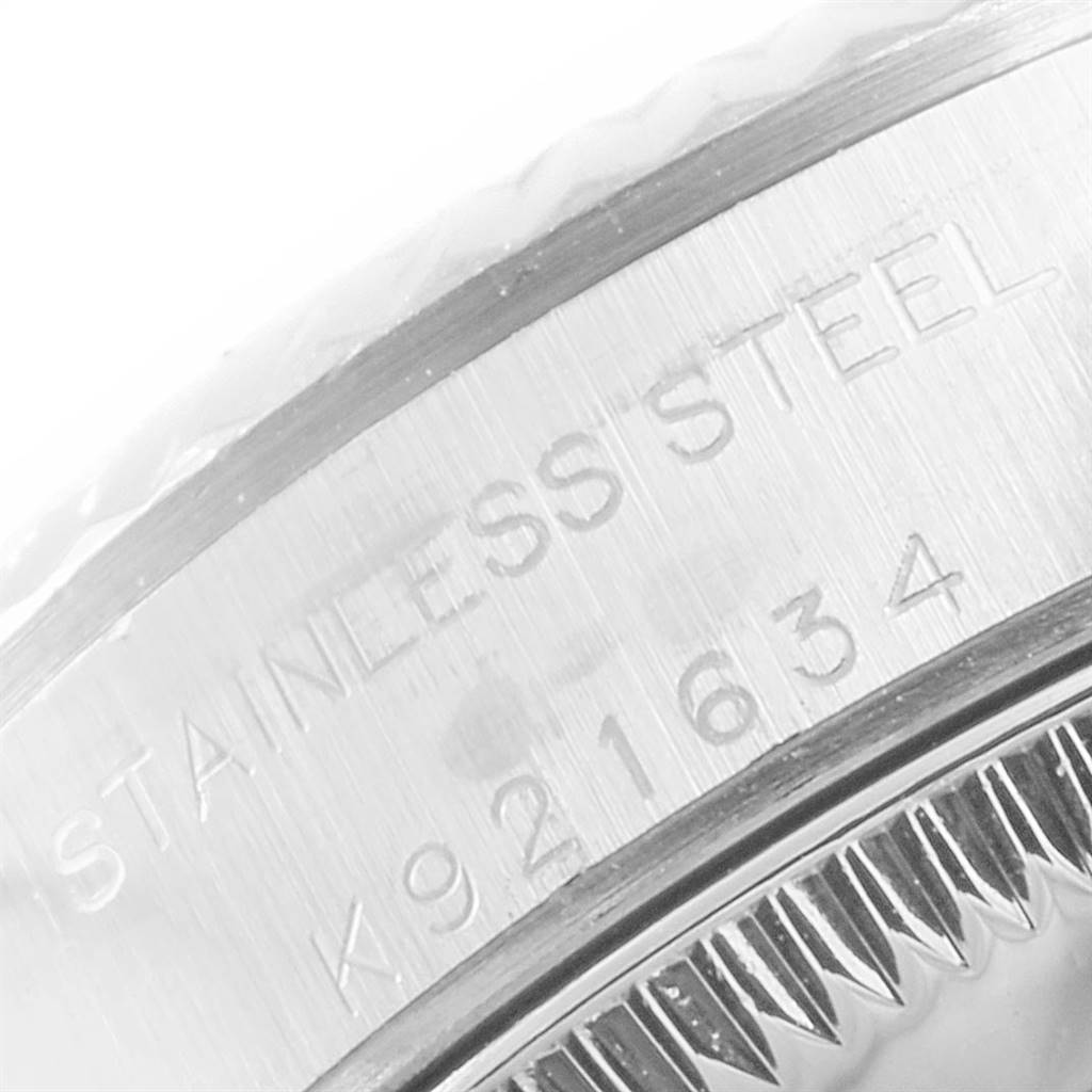 This close-up image shows the engraved detail on the stainless steel casing of the Rolex Oyster Perpetual 76094 Women's Stainless Steel Silver Dial 76094 Women's Stainless Steel Silver Dial watch.