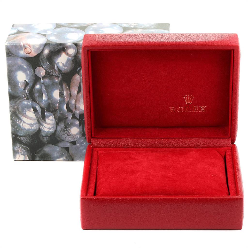 The image shows an empty red Rolex watch box for the Oyster Perpetual model with a decorative outer box.