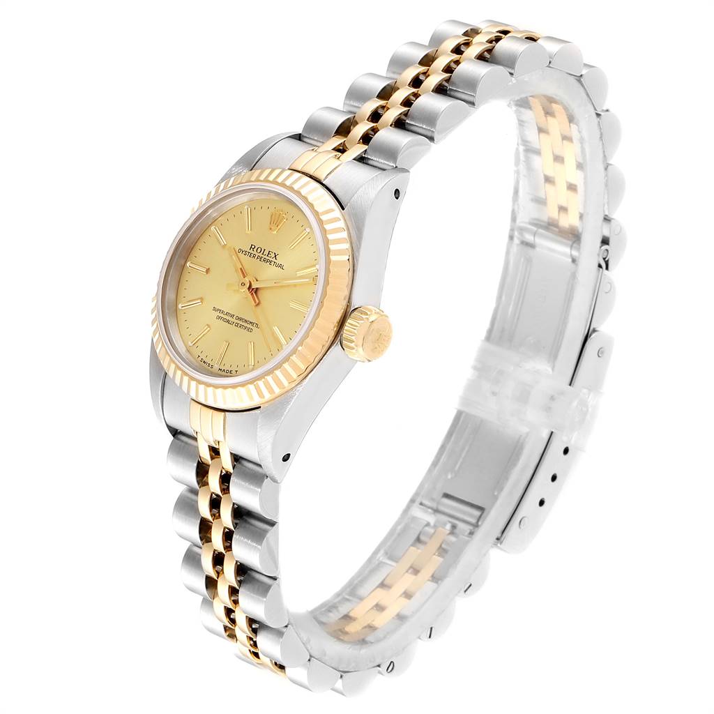 The Rolex Oyster Perpetual 67193 Women
s Steel and Gold (two tone) Champagne Dial 67193 Women
s Steel and Gold (two tone) Champagne Dial watch is shown at a side angle, highlighting its two-tone bracelet and gold bezel.