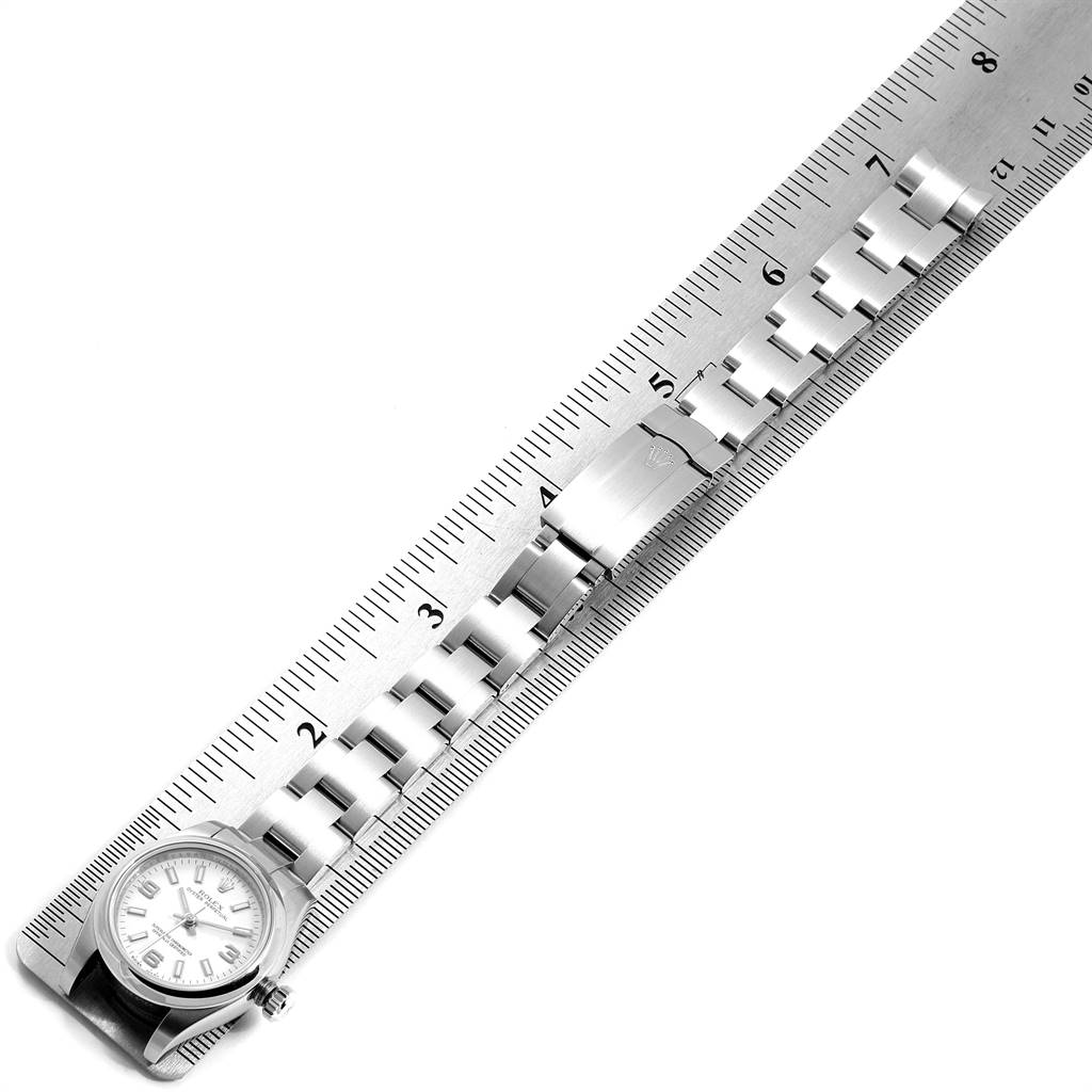 The image shows a Rolex Oyster Perpetual 176200 Women's Stainless Steel White Dial 176200 Women's Stainless Steel White Dial watch laid flat with its metal bracelet positioned alongside a ruler for measurement.