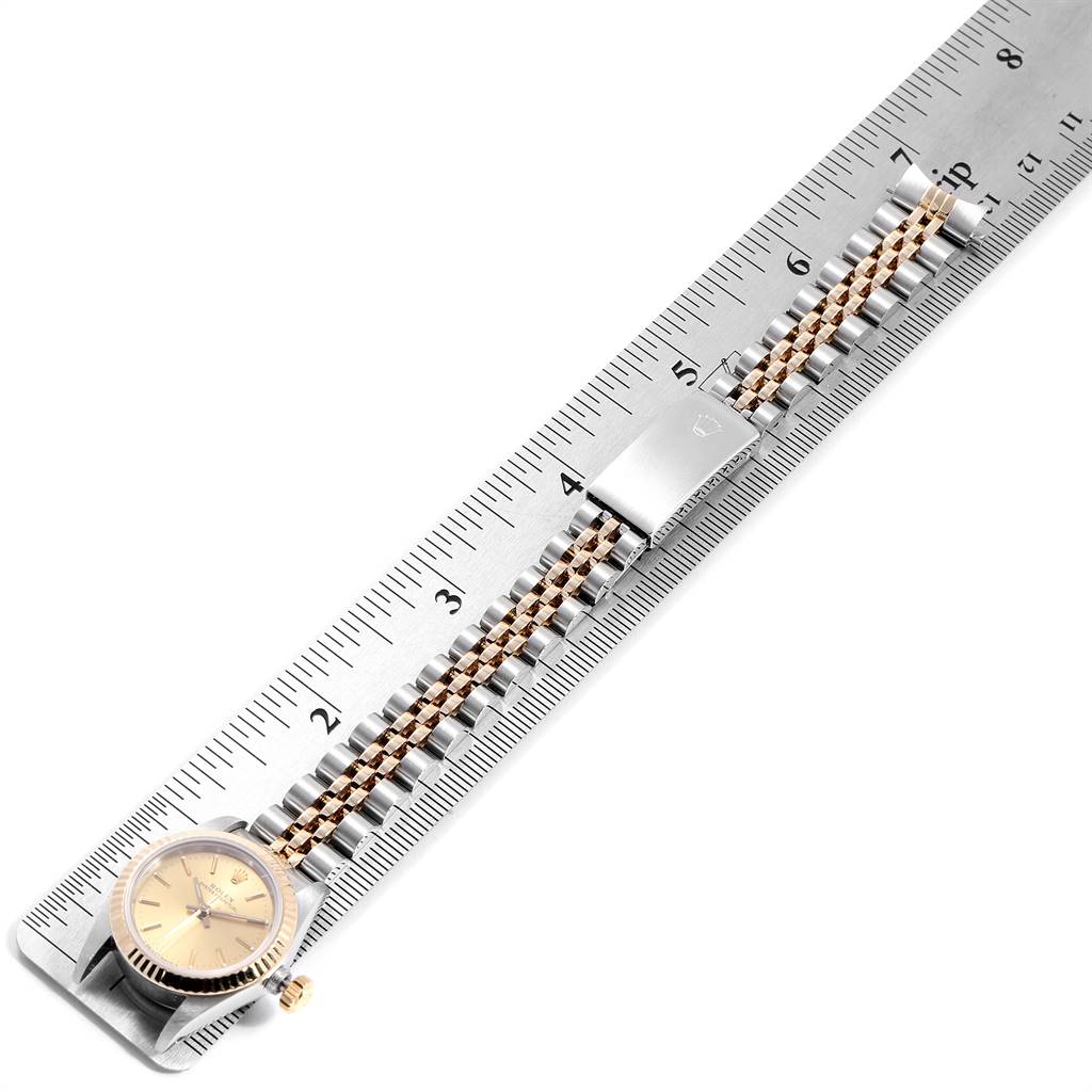 The Rolex Oyster Perpetual 67193 Women
s Steel and Gold (two tone) Champagne Dial 67193 Women
s Steel and Gold (two tone) Champagne Dial watch is shown from a top-down angle, displaying the watch face and full bracelet.