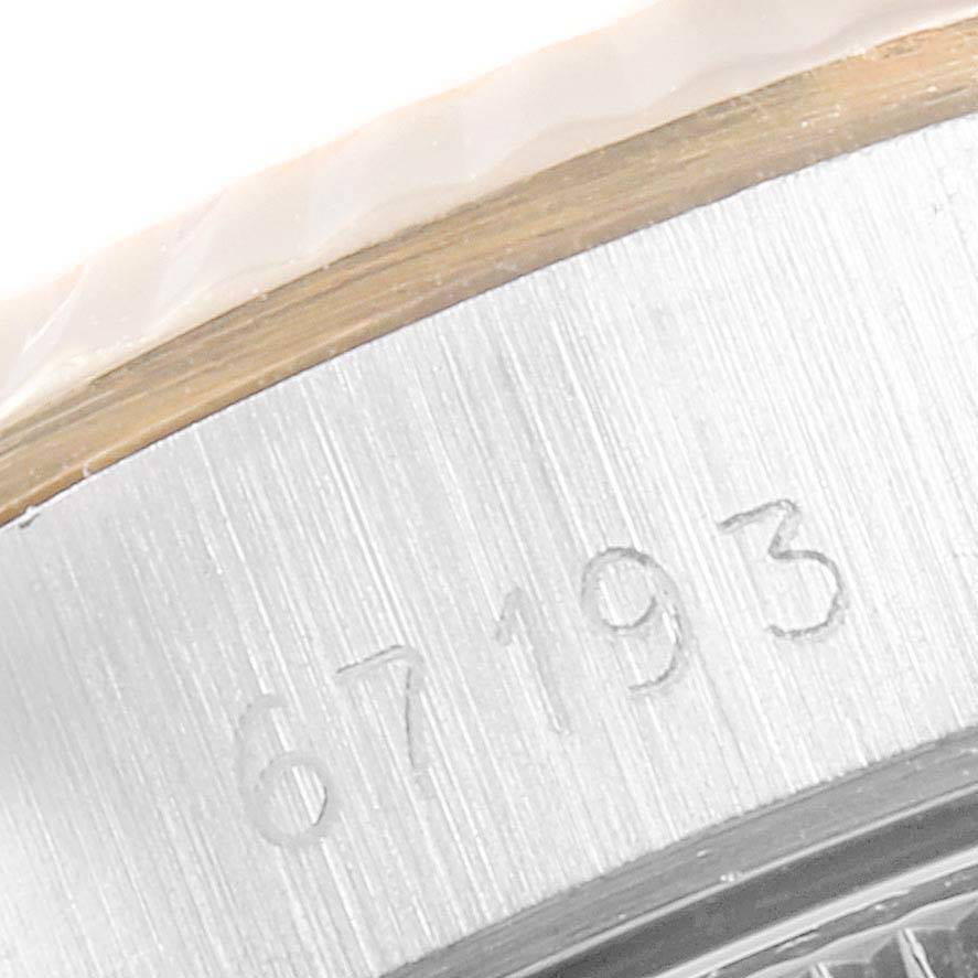 This close-up image shows the serial number engraving on the case of a Rolex Oyster Perpetual 67193 Women
s Steel and Gold (two tone) Champagne Dial 67193 Women
s Steel and Gold (two tone) Champagne Dial watch.