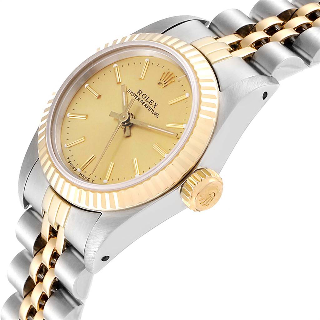 The image shows a side view of a Rolex Oyster Perpetual 67193 Women
s Steel and Gold (two tone) Champagne Dial 67193 Women
s Steel and Gold (two tone) Champagne Dial watch displaying its golden bezel, crown, dial, and part of the bracelet.