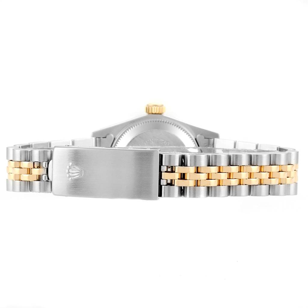 The image shows the back view of a Rolex Oyster Perpetual 67193 Women
s Steel and Gold (two tone) Champagne Dial 67193 Women
s Steel and Gold (two tone) Champagne Dial watch, focusing on the stainless steel and gold bracelet and clasp.