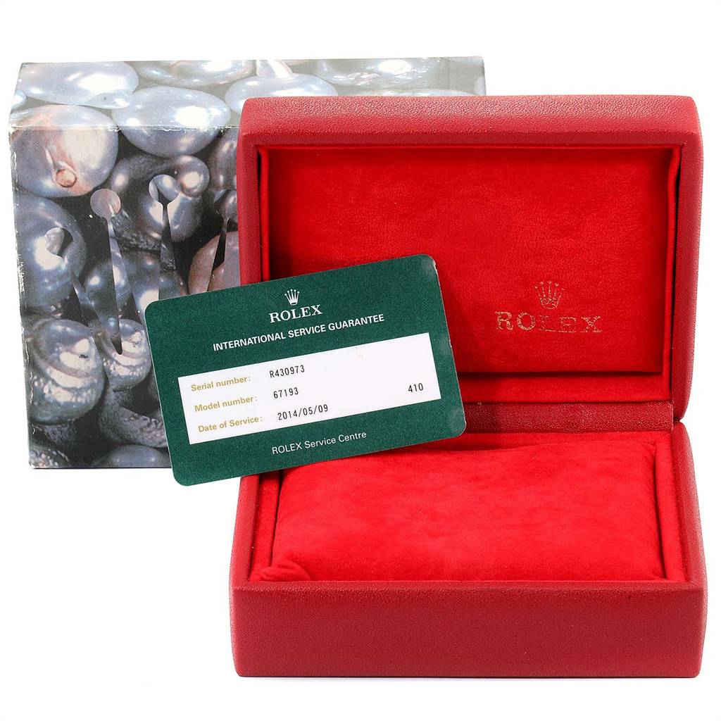 The image shows the open box and guarantee card of a Rolex Oyster Perpetual 67193 Women
s Steel and Gold (two tone) Champagne Dial 67193 Women
s Steel and Gold (two tone) Champagne Dial model.