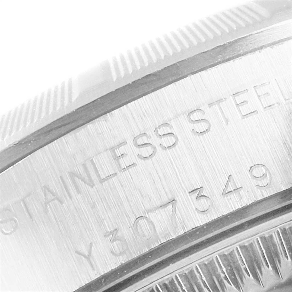 The image shows a close-up of the stainless steel casing and serial number of a Rolex Oyster Perpetual 76030 Women
s Stainless Steel Blue Dial 76030 Women
s Stainless Steel Blue Dial watch.