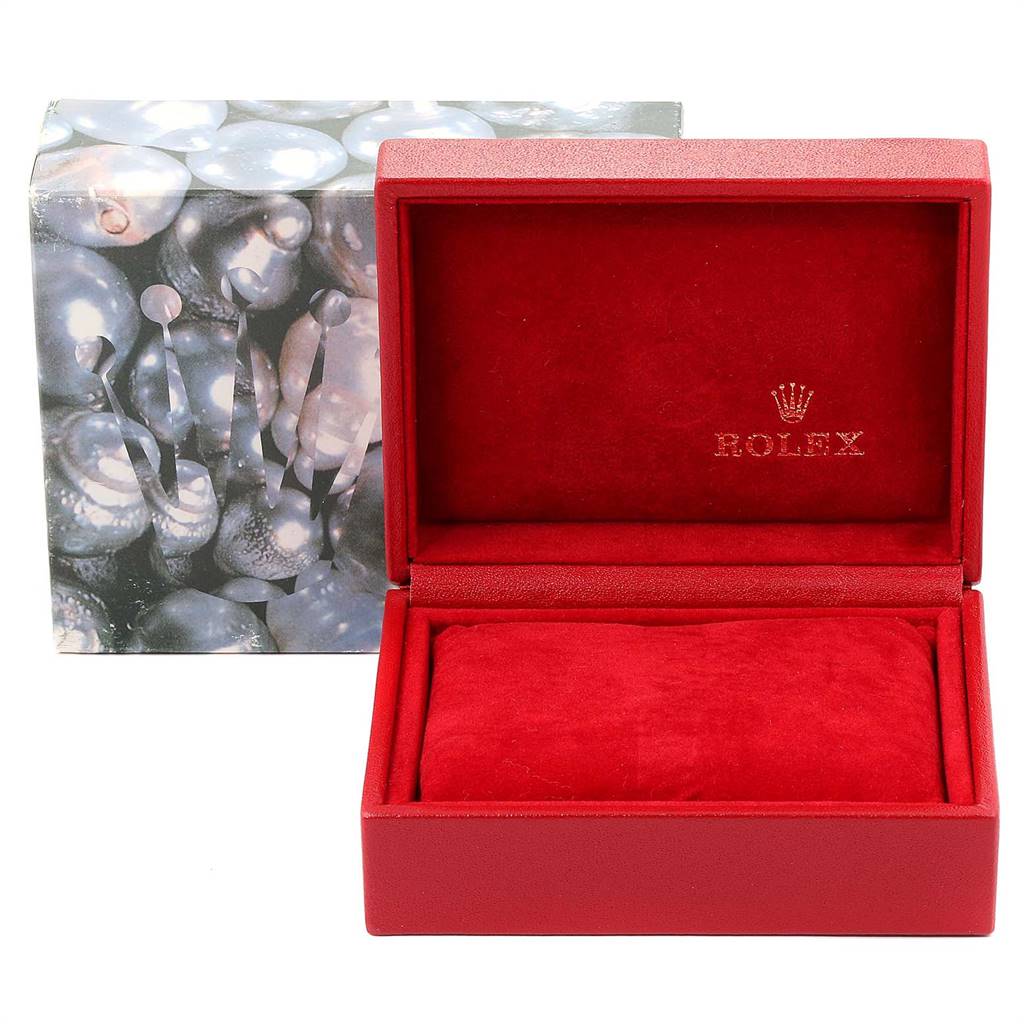 The image shows a red Rolex Oyster Perpetual 76094 Women's Stainless Steel Silver Dial 76094 Women's Stainless Steel Silver Dial watch box, open with a cushion inside and a decorative outer box behind it.