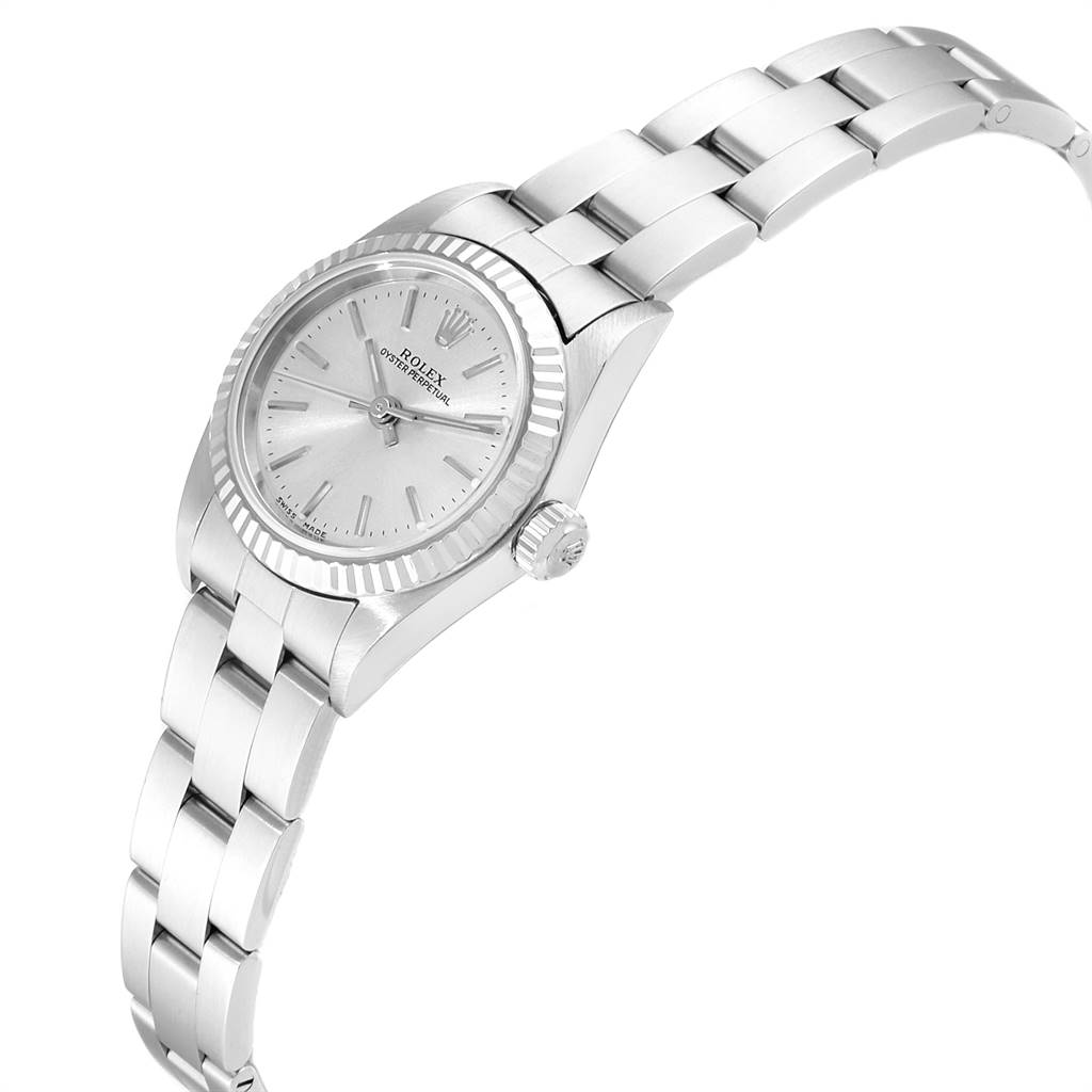 The image shows a side angle of the Rolex Oyster Perpetual 76094 Women's Stainless Steel Silver Dial 76094 Women's Stainless Steel Silver Dial watch highlighting its face, bezel, crown, and bracelet.