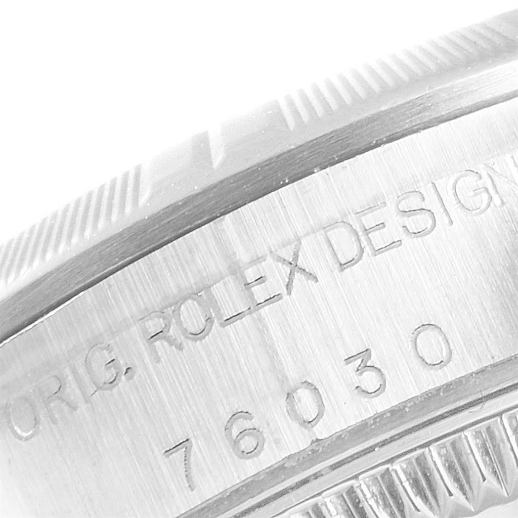 This image shows a close-up angle of the side markings and bezel of a Rolex Oyster Perpetual 76030 Women's Stainless Steel Pink Dial 76030 Women's Stainless Steel Pink Dial watch, displaying its design and model number.