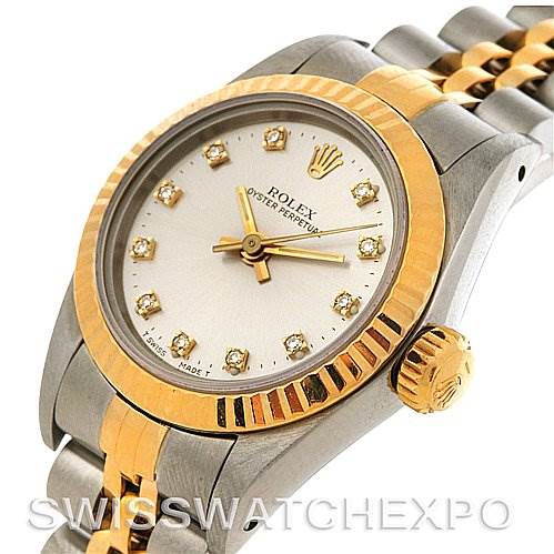 This image shows the face, bezel, crown, and part of the bracelet of a Rolex Oyster Perpetual 67193 Women's Steel and Gold (two tone) Silver Dial 67193 Women's Steel and Gold (two tone) Silver Dial watch from an angled perspective.