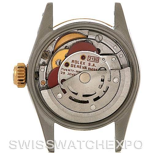 The image shows the inner movement mechanism of a Rolex Oyster Perpetual 67193 Women's Steel and Gold (two tone) Silver Dial 67193 Women's Steel and Gold (two tone) Silver Dial watch from the back view, revealing intricate gears and components.