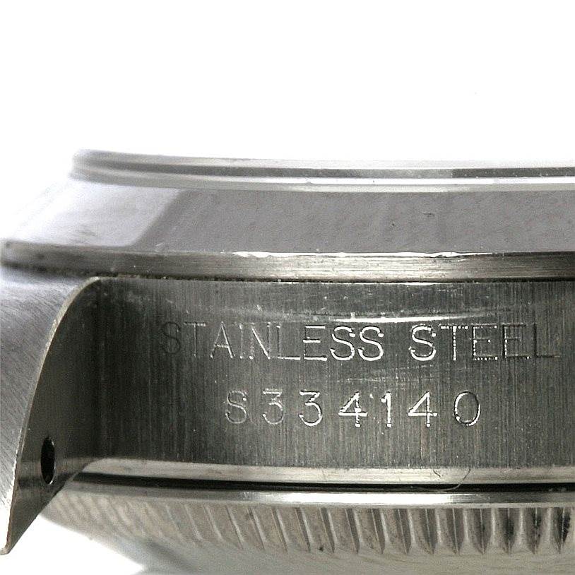 This image shows a close-up side view of the case edge and serial number of a Rolex Oyster Perpetual 67180 Women's Stainless Steel White Dial 67180 Women's Stainless Steel White Dial watch.