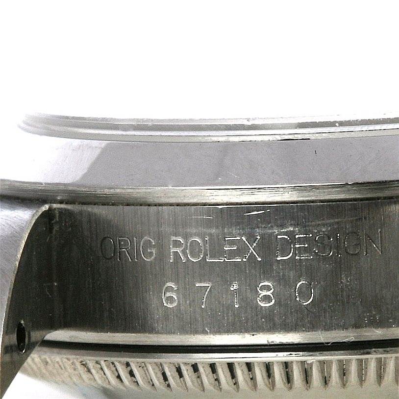 This is a close-up shot of the side casing of a Rolex Oyster Perpetual 67180 Women's Stainless Steel White Dial 67180 Women's Stainless Steel White Dial watch, showing the engraved design and model number.