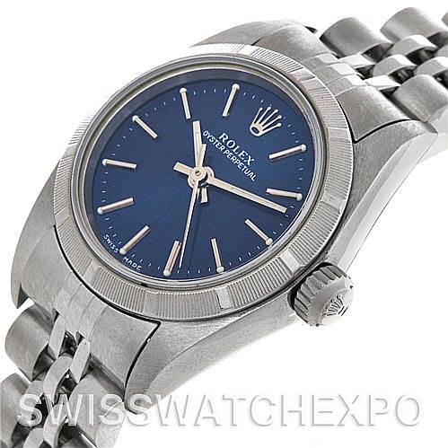 This image shows a side angle of a Rolex Oyster Perpetual 67180 Women's Stainless Steel Blue Dial 67180 Women's Stainless Steel Blue Dial watch, highlighting its blue dial, crown, and part of the bracelet.