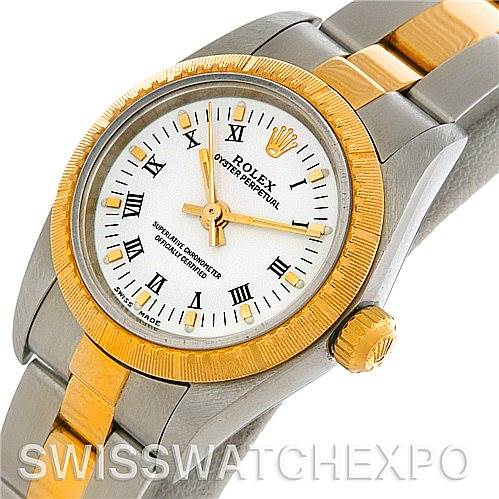 The image shows a close-up of the Rolex Oyster Perpetual 76243 Women's Steel and Gold (two tone) White Dial 76243 Women's Steel and Gold (two tone) White Dial watch, highlighting the bezel, crown, dial, and bracelet.