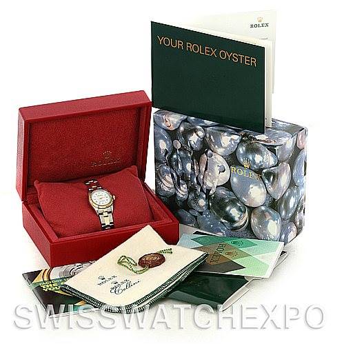 This image shows the Rolex Oyster Perpetual 76243 Women's Steel and Gold (two tone) White Dial 76243 Women's Steel and Gold (two tone) White Dial watch in a red box, with accompanying booklets and packaging materials.