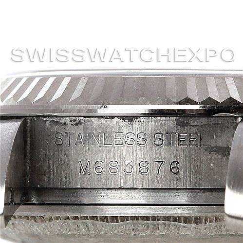 The image shows a close-up of the side of a Rolex Oyster Perpetual 176234 Women's Stainless Steel White Dial 176234 Women's Stainless Steel White Dial watch casing, highlighting the stainless steel text and serial number.
