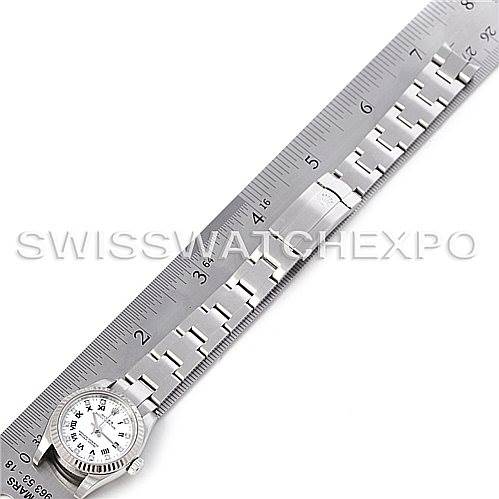 This image shows an Oyster Perpetual Rolex watch laid flat and measured with a ruler, showcasing the watch face and part of the bracelet.