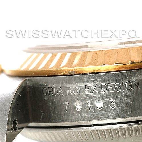 This close-up image of the Rolex Oyster Perpetual 67193 Women's Steel and Gold (two tone) Champagne Dial 67193 Women's Steel and Gold (two tone) Champagne Dial watch showcases part of the case, bezel, and engravings.