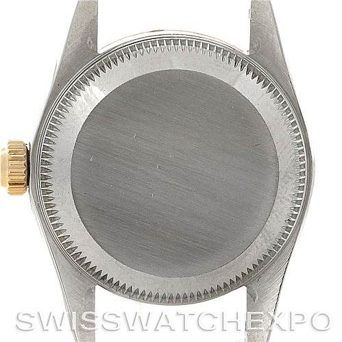 This image shows the back case and crown of a Rolex Oyster Perpetual 67193 Women's Steel and Gold (two tone) Champagne Dial 67193 Women's Steel and Gold (two tone) Champagne Dial watch from a straight-on angle.